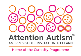 Logo for Attention Autism. Shows lots of small circles some hollow and some with smiling faces in them. Logo orange and pink